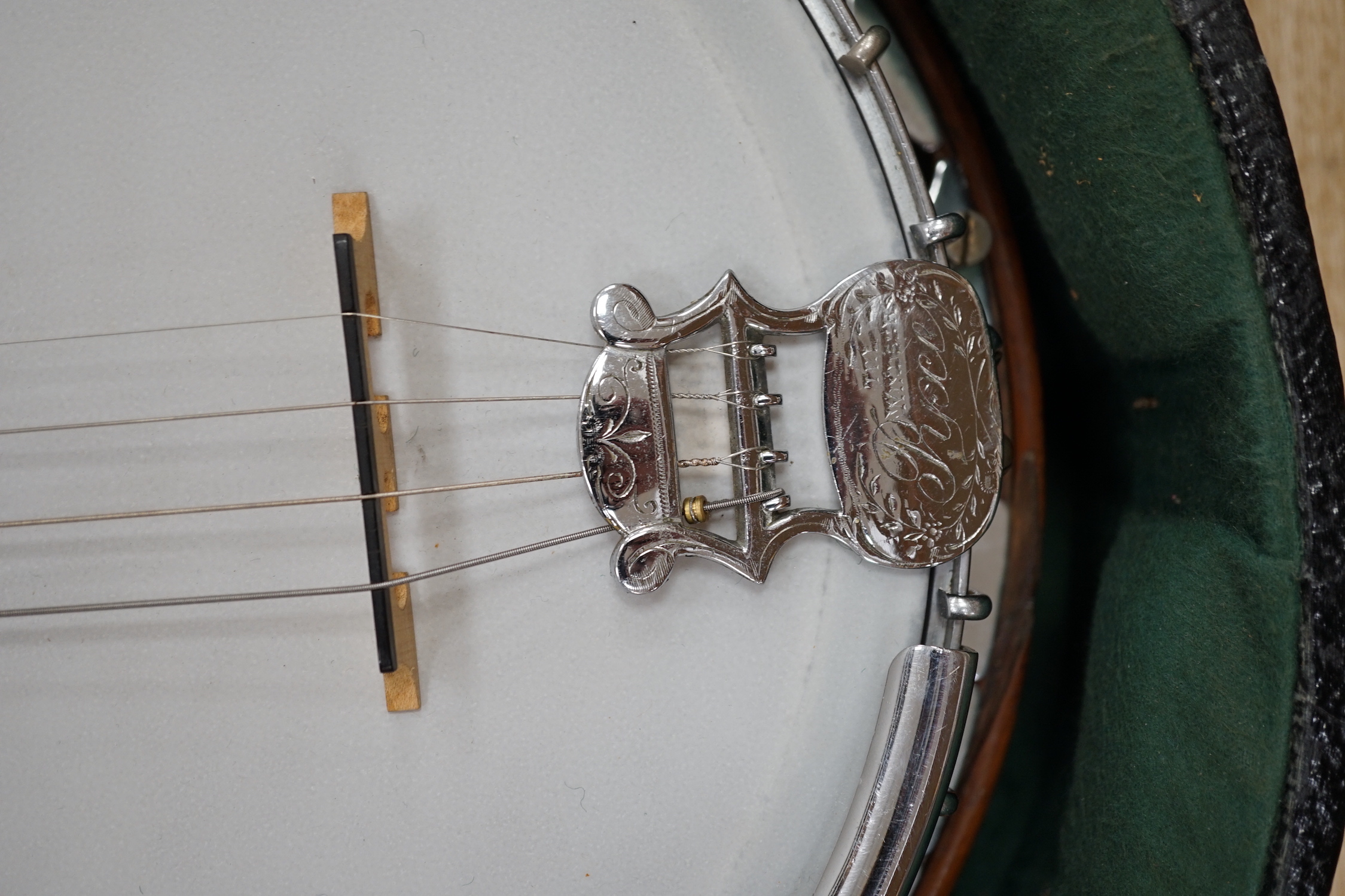 A cased English 1930s Windsor Whirl four string tenor banjo, mother of pearl inlaid neck, length of body 33cm, overall length 84cm, in fitted case